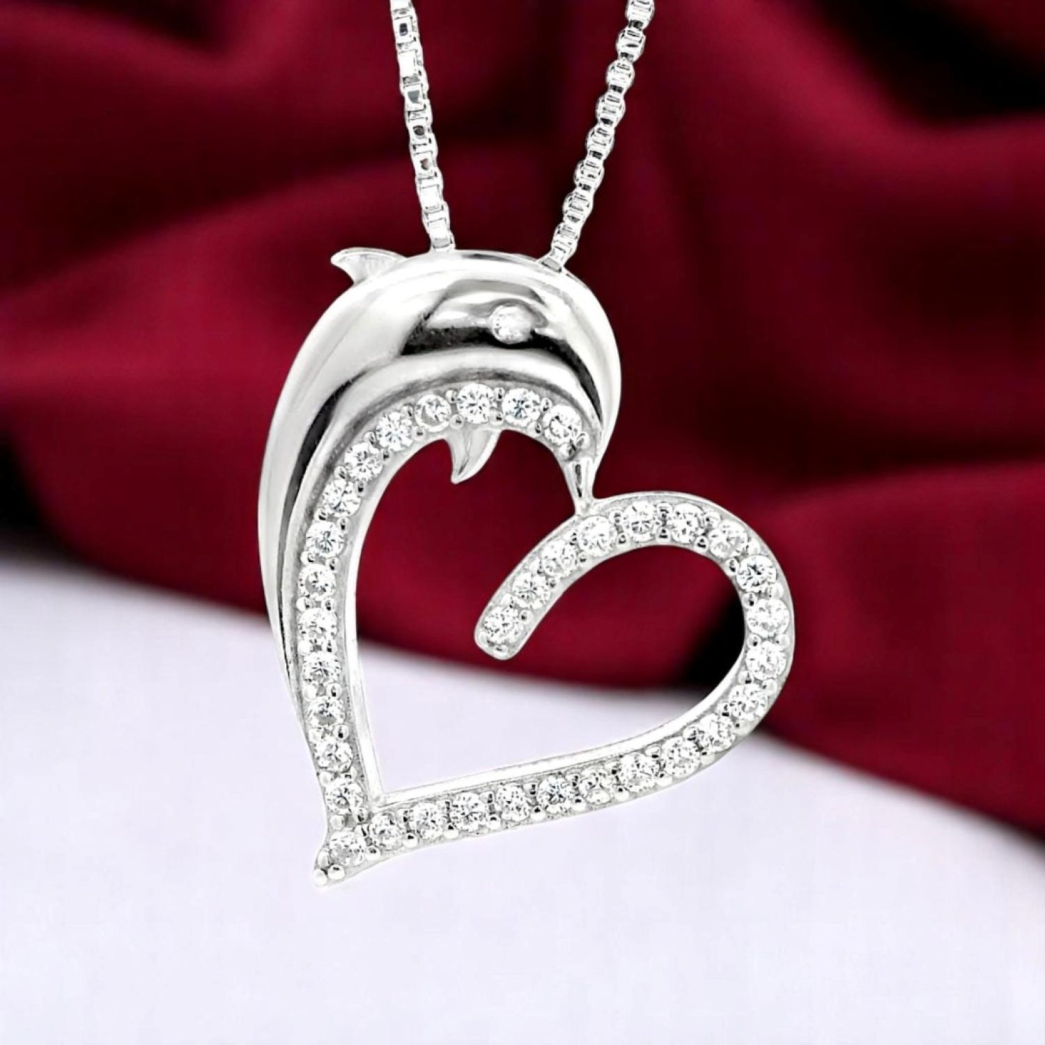 Silver "Dolphin Heart Pendant – A Symbol of Love & Ocean Elegance Silver Dolphin Heart Pendant with a leaping dolphin and sparkling heart outline—symbolizing love and freedom