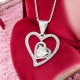 Interlocking Heart Pendant Necklace Interlocking Heart Pendant Necklace | Elegant pendant featuring two interlocking hearts—one adorned with sparkling stones and the other holding a central heart-shaped gemstone, symbolizing love and connection.