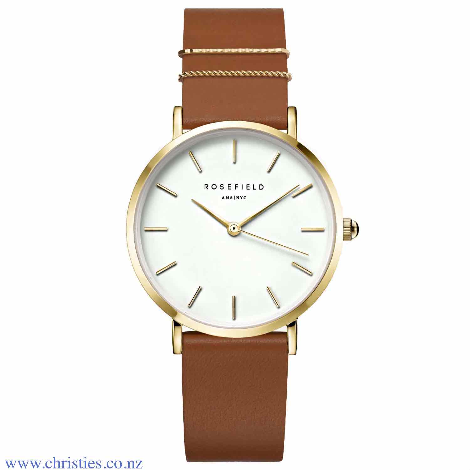 WWCG-W86 Rosefield The West Village Blush Cognac Gold Watch. The West Village collection is inspired by the iconic New York neighbourhood. The velvety nubuck leather straps give the watch a city character, with chic metal rings that keep it classy. Afterp