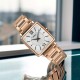 SWR112P Seiko Ladies Analogue Square Watch – Rose gold-tone stainless steel case, white dial with Roman numerals, and a sleek stainless-steel bracelet for timeless elegance.