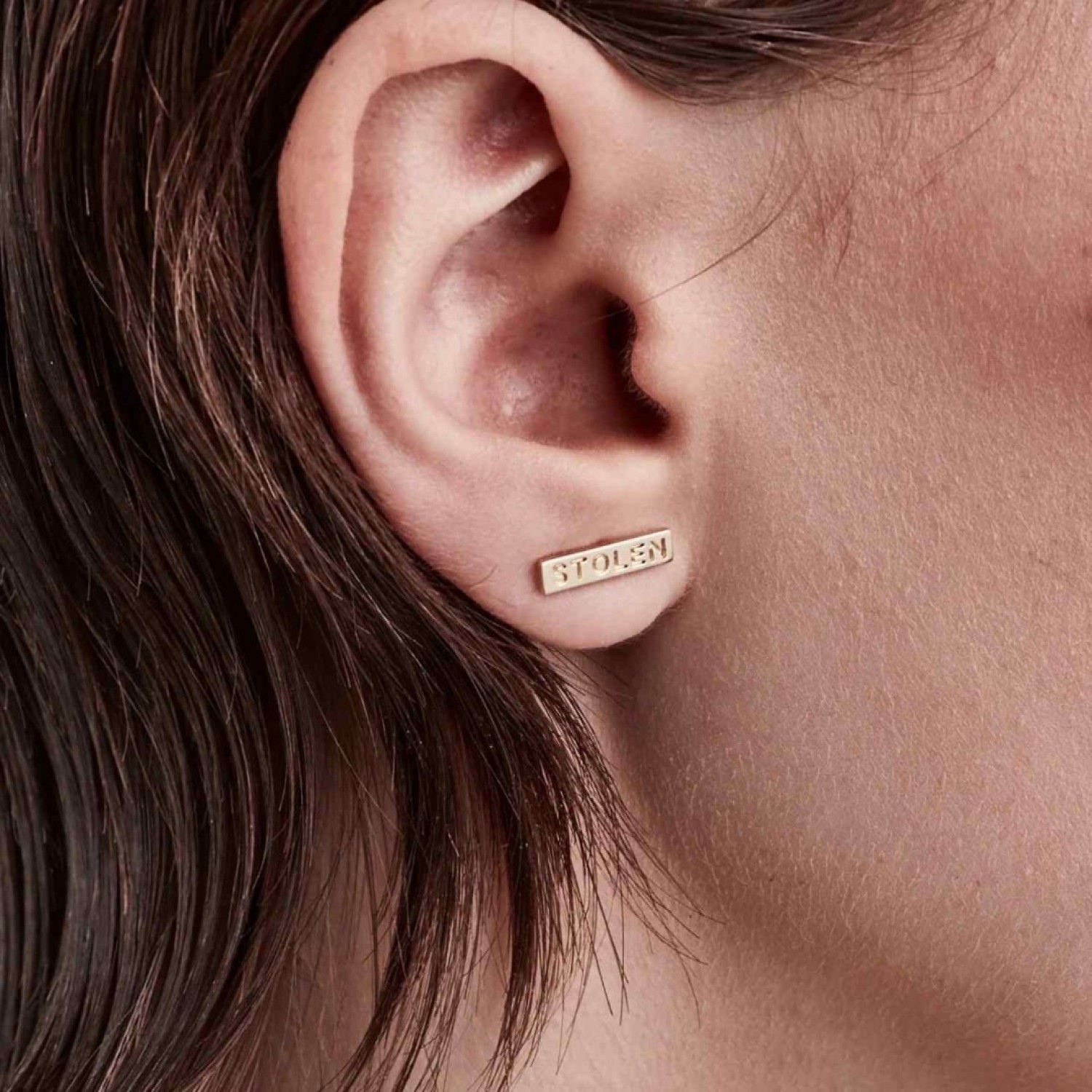 TINY STOLEN BAR EARRINGS - GOLD PLATED – Stolen Girlfriends Club Jewellery TINY STOLEN BAR EARRINGS - GOLD PLATED by Stolen Girlfriends Club Jewellery | Bar shaped earring with Stolen engraved with butterfly fastening