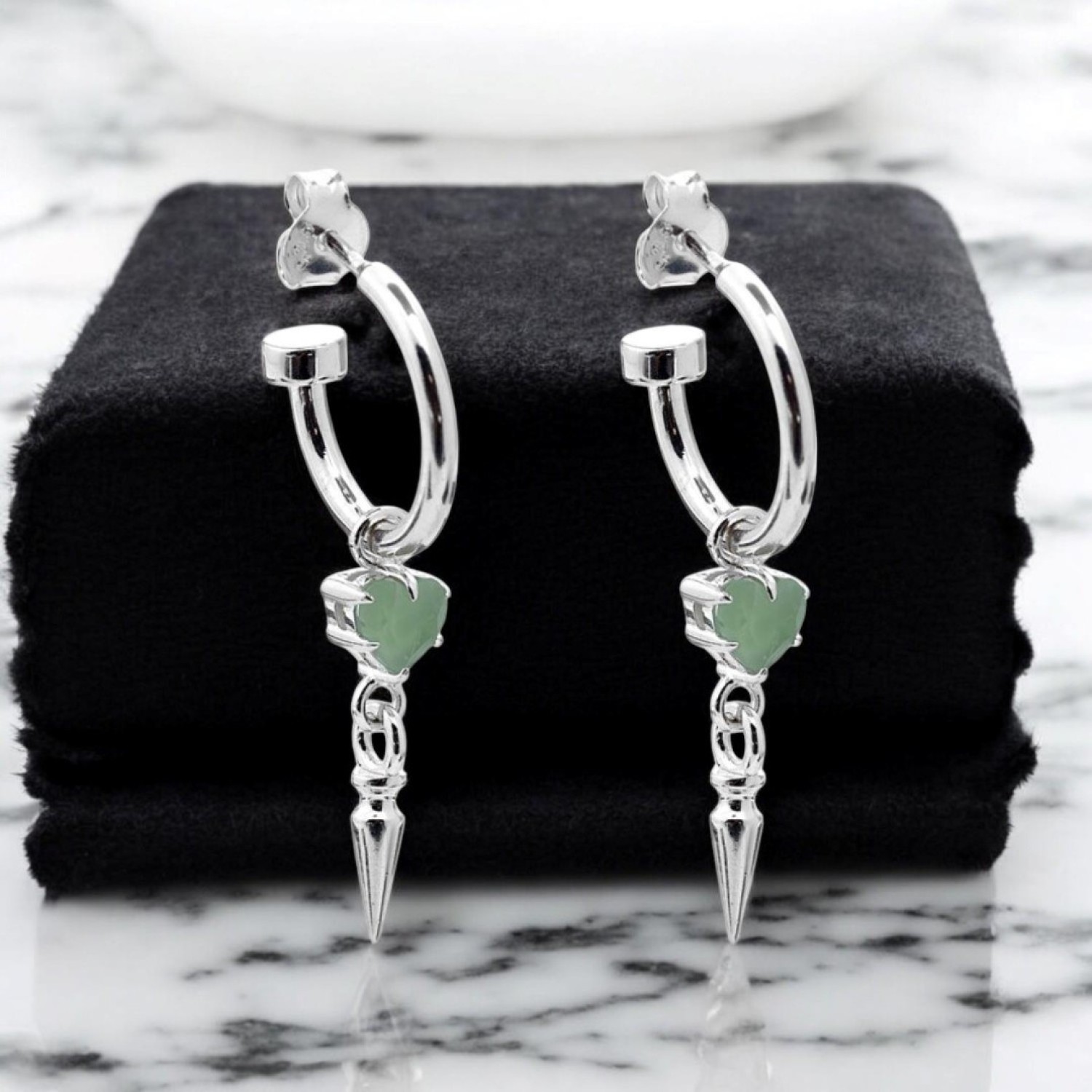 "PUNK SPIKE ANCHOR EARRINGS – Sterling Silver Hoops with Green Amethyst Heart and Spike Pendants PUNK SPIKE ANCHOR EARRINGS by Stolen Girlfriends Club, featuring sterling silver hoops adorned with green heart-shaped amethyst charms and bold spike pendants.
