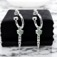 "PUNK SPIKE ANCHOR EARRINGS – Sterling Silver Hoops with Green Amethyst Heart and Spike Pendants PUNK SPIKE ANCHOR EARRINGS by Stolen Girlfriends Club, featuring sterling silver hoops adorned with green heart-shaped amethyst charms and bold spike pendants.