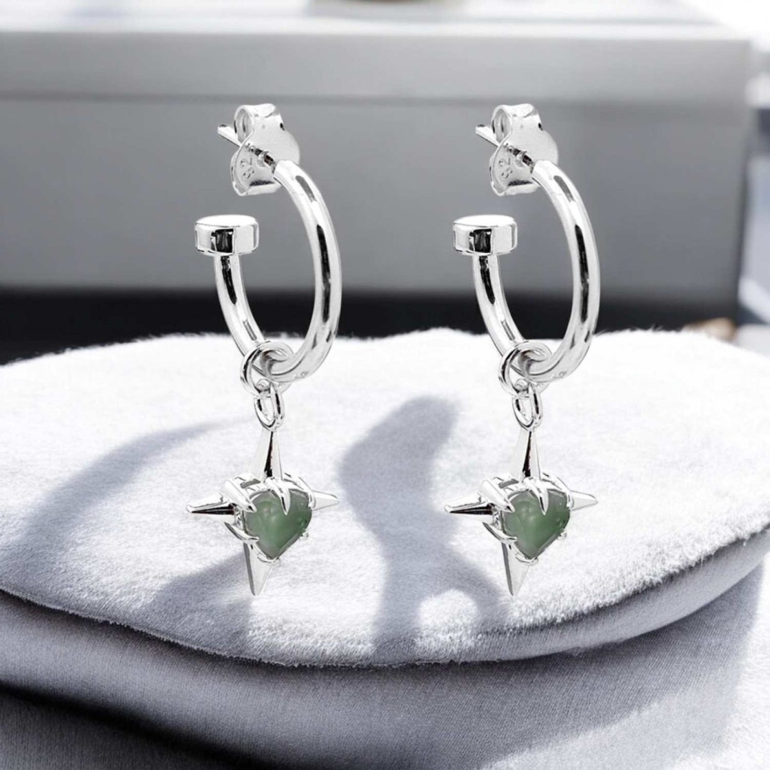 PRECIOUS PUNK ANCHOR EARRINGS – Sterling Silver Hoops with Green Amethyst Heart Charms PRECIOUS PUNK ANCHOR EARRINGS by Stolen Girlfriends Club, featuring heart-shaped green amethyst stones suspended on polished sterling silver hoops with butterfly fastenings.