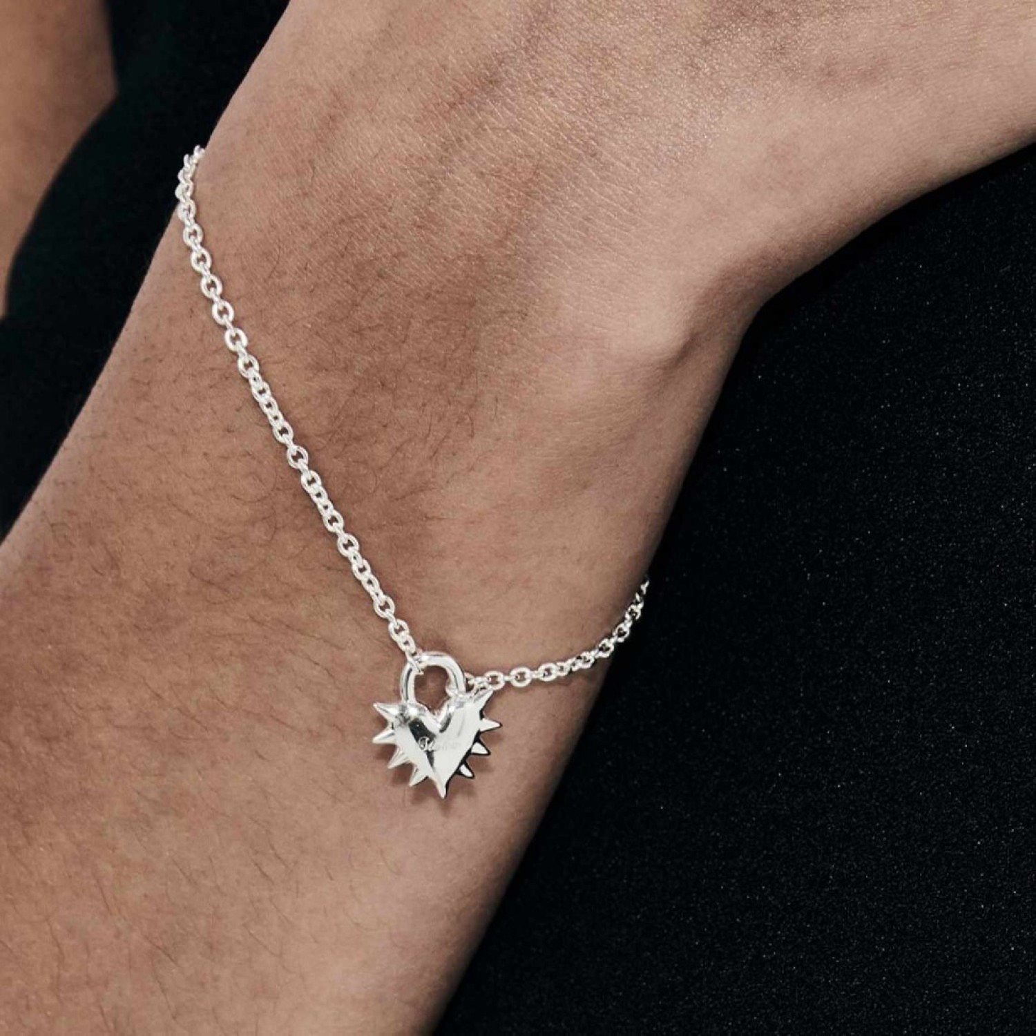 Love Locket Bracelet – Romantic Silver Heart Padlock Charm | Stolen Girlfriends Club Jewellery Love Locket Bracelet by Stolen Girlfriends Club Jewellery | Silver chain bracelet with a spiked heart-shaped padlock charm engraved with 'Stolen' and a lobster clasp closure.