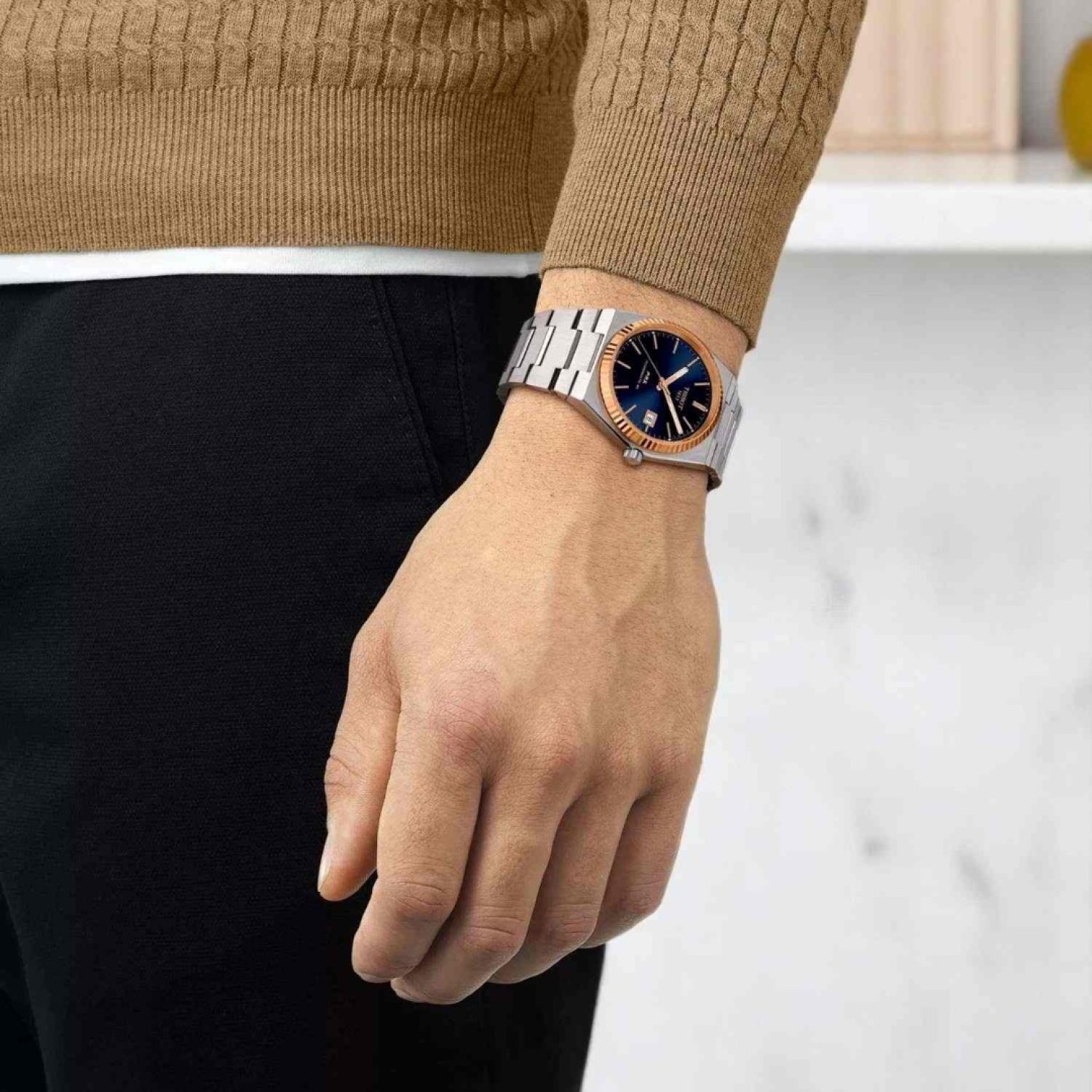 TISSOT PRX Powermatic 80 18K Gold Bezel 40mm T9314074104100 by Tissot Watches NZ | Tissot PRX Powermatic 80 with a rose gold bezel, black dial, and stainless steel bracelet, featuring sleek hour markers and a date window at 3 o'clock.