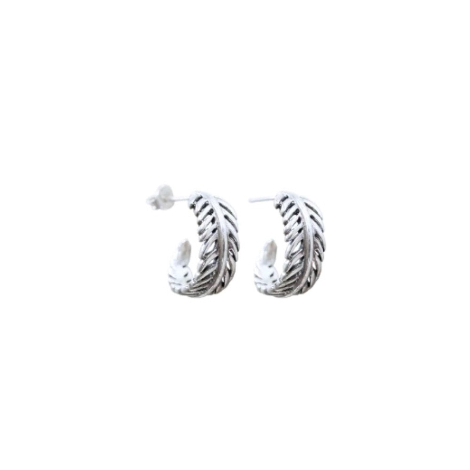 Evolve Forever Fern Hoop Earrings Close-up of Evolve Forever Fern Hoop Earrings featuring a silver fern motif wrapped around the hoops.