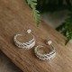 Evolve Forever Fern Hoop Earrings Close-up of Evolve Forever Fern Hoop Earrings featuring a silver fern motif wrapped around the hoops.