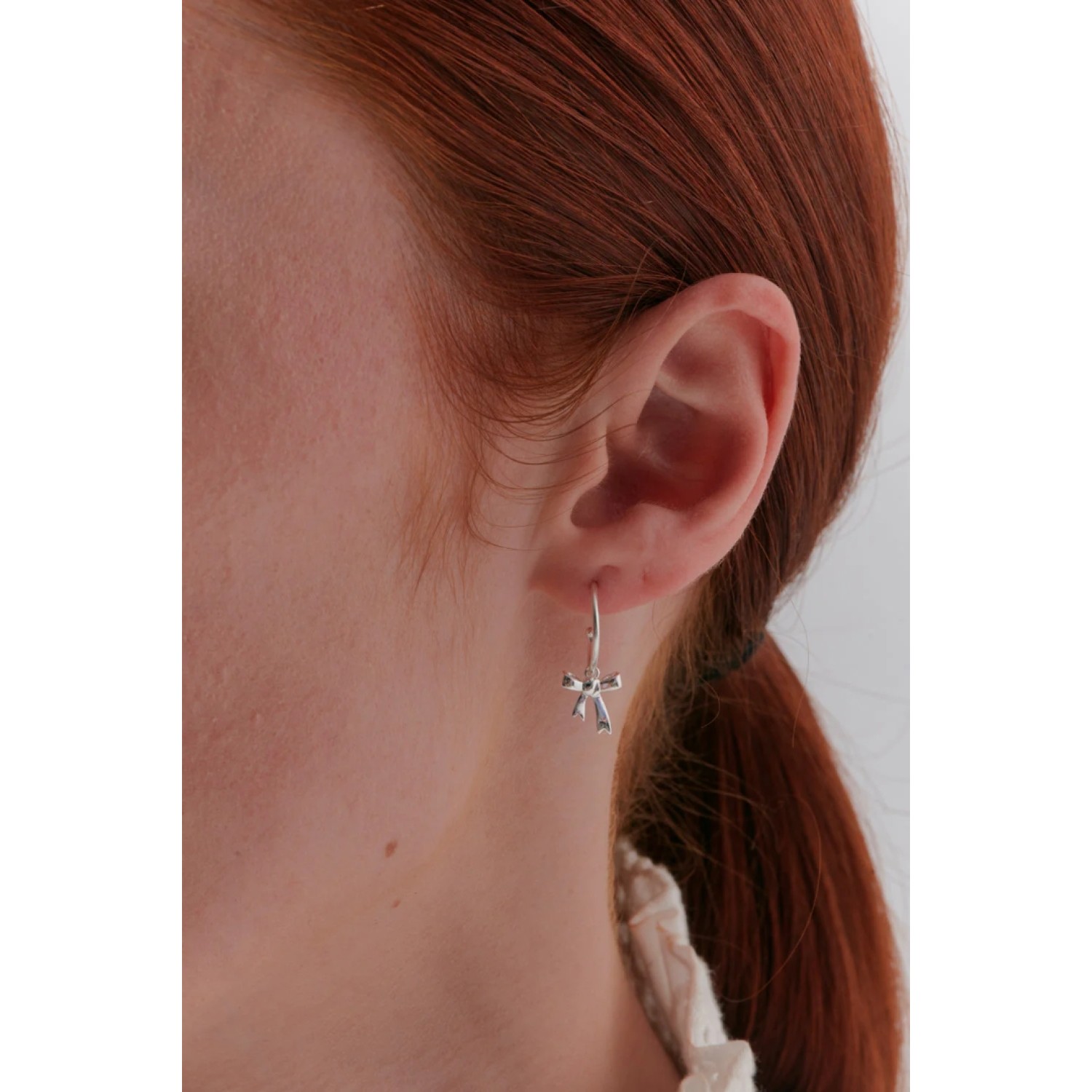 Karen Walker Sterling Silver Bow Hoop Earrings Karen Walker Bow Hoop Earrings in sterling silver with signature bow charm detail